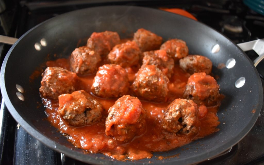 Grass Fed Beef and Quinoa Meatballs cooking with sauce