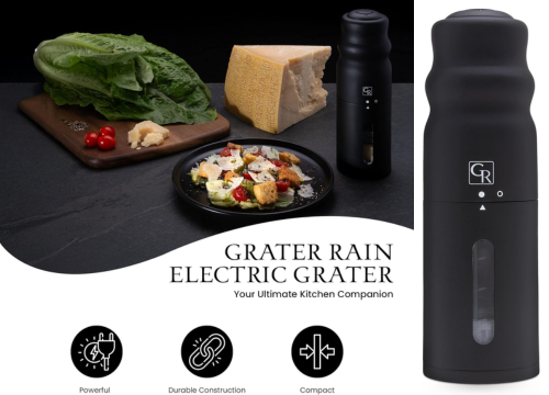 A promotional poster showcases the "Grater Rain Electric Grater," a sleek black kitchen appliance positioned as "Your Ultimate Kitchen Companion." The scene features culinary elements: a partially grated block of Parmesan cheese, fresh romaine lettuce, a few red cherry tomatoes on a wooden board, and a black plate of Caesar salad generously topped with grated cheese and croutons. The electric grater is shown in the center and in a close-up on the right, highlighting its design with a transparent window. Three icons at the bottom emphasize its "Powerful" operation (lightning bolt), "Durable Construction" (chain links), and "Compact" size (inward arrows). The grater prominently displays the "GR" logo. The overall aesthetic is modern and kitchen-focused, set against a dark countertop.