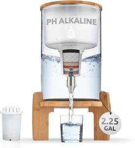 Alkaline Water Filter Pitcher and Dispenser placed on the wooden shelf and filtering water into a glass.