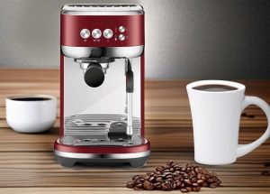 Red Velvet Cake Breville Bambino Plus Espresso Machine on the table along with two cups and coffee beans spreading on the table.
